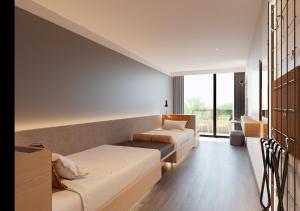 a living room with two beds and a couch at Expo Hotel Barcelona in Barcelona