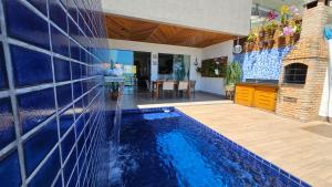 a swimming pool in a house with a water fountain at A CASA FORMOSA in Baía Formosa
