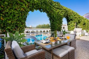 un patio al aire libre con una mesa con comida. en Clube Vilarosa, en Portimão