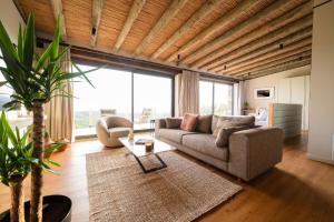 a living room with a couch and a table at MANİCİ ÇİFTLİK in Ayvacık