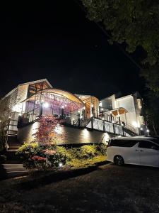 a white car parked in front of a building at night at FUJIYUKI in Yamanakako