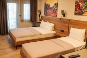 a hotel room with two beds in a room at Şenyıldız Hotel in İzmir