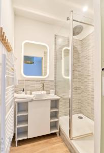 a bathroom with a sink and a shower at LA LOGE DES CARMES -Coeur de Nantes WIFI in Nantes
