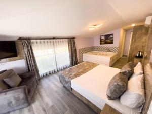 a bedroom with a large bed and a couch at Castle Light Boutique in Alanya