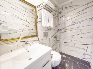 a white bathroom with a sink and a mirror at Castle Light Boutique in Alanya +48 photos