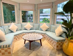 a living room with a couch and a table at Kyriad Cannes - Mandelieu in Cannes