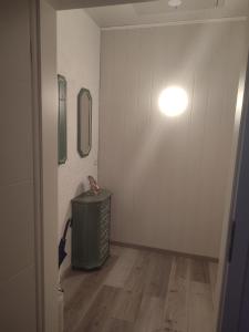 a hallway with a green trash can and a light at Ferienwohnung Monecke in Hürtgenwald