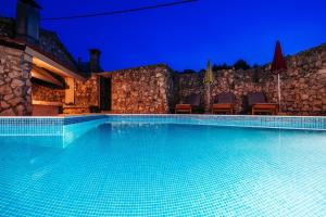 a swimming pool in a villa at night at Villa Lily Comfortable holiday residence in Veli Iž +56 photos