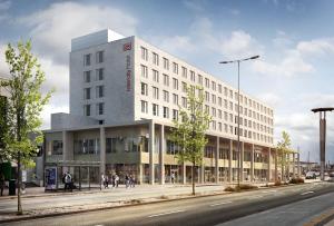 a large white building on a city street at IntercityHotel Paderborn in Paderborn