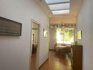 a hallway with a table and a dining room at HomefromHomees B&B in Sant Feliu de Guixols