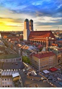 an overhead view of a city with buildings and a clock tower at Schwabing-Studio great sunset view & balcony in Munich