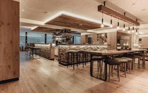 a dining room with a large table and chairs at Hotel Schütterhof in Schladming