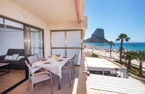 - une salle à manger avec une table et une vue sur la plage dans l'établissement Edificio Calpemar, à Calp