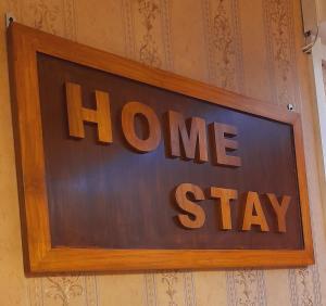 a sign that says home stay on a wall at Homestay Ac Dormitory in New Delhi