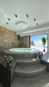 a swimming pool with a jacuzzi in a house at Vila Golija in Kopaonik