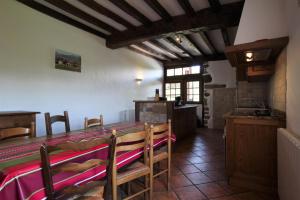 a kitchen with a table and chairs in a room at Zamatelua 2 in Sare