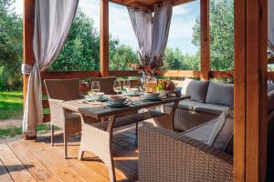 a patio with a table and chairs and a couch at House no 2 in Pakoštane +26 photos