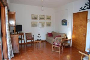 a living room with a couch and a table at VILLA DOLPHIN VOTSI in Votsi