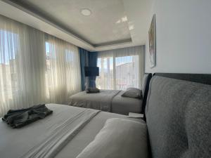 a hotel room with two beds and a window at Mert Homes Marmaris in Marmaris