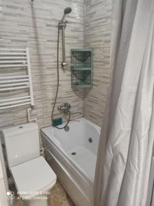a bathroom with a tub and a toilet and a shower at Гостевой дом "Наталья" in K'obulet'i