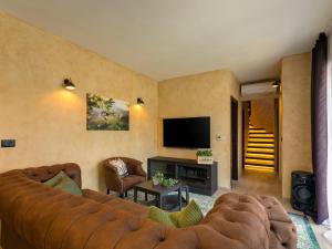a living room with a couch and a television at Vila Maslina in Nova Vas