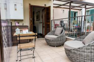 2 Korbstühle und ein Tisch auf dem Balkon in der Unterkunft Patty’s House [Centro storico a 5 min] in Pesaro