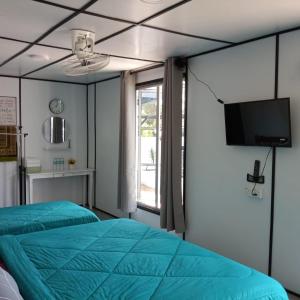 מיטה או מיטות בחדר ב-Rimbun Bayu Homestay