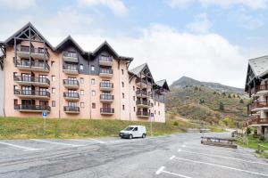 una macchina bianca parcheggiata di fronte a un edificio di Le Crey du Quart a Valmeinier