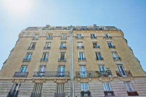ein hohes Gebäude mit Balkon an der Seite in der Unterkunft Luxury typical Parisian apartment in Saint-Ouen