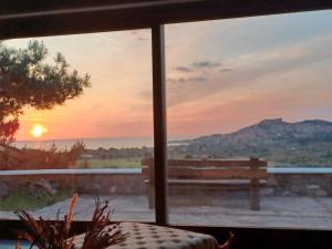 a view of a sunset from a window at Molivos Castleview Luxury Villa with private parking in Mythimna