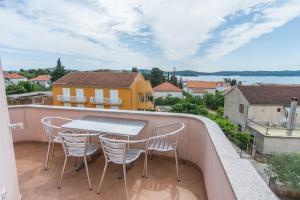 a patio with a table and chairs on a balcony at Apartments Basilea No. 2 in Biograd na Moru