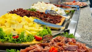 a buffet of food with cheese and meat and other foods at Queen Nelly in Primorsko