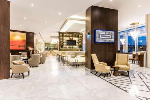 a lobby of a hotel with chairs and a bar at Hyatt Regency San Luis Potosi in San Luis Potosí +45 photos