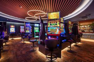 a casino with many slot machines and a bar at Nightcap at Rex Hotel in Adelaide