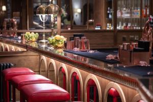 a bar with red stools in a restaurant at The White Hart Hotel Lincoln in Lincoln
