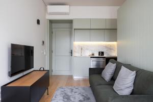 a living room with a couch and a tv at ORM Batalha Apartments in Porto