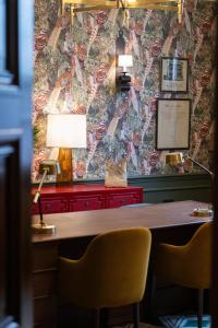 a desk with two chairs and a table with a lamp at The White Hart Hotel Lincoln in Lincoln