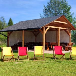 a group of four chairs in front of a pavilion at Osada Indiańska in Ostrów Podlaski