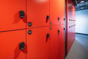 a row of red lockers in a gym at City Trip Hostels Zaandam-Amsterdam in Zaandam