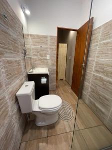 a bathroom with a toilet and a sink at HOTEL BL in Puerto Iguazú +48 photos