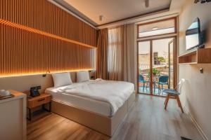 a hotel room with a bed and a window at Vermont Boutique Hotel in Tbilisi City