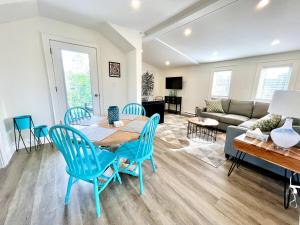 a living room with a table and chairs and a couch at "Paddle" at Hills Meaford, Penthouse 3rd Floor Suite w Deck & Balcony in Meaford