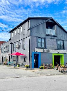 a building with a building with bikes parked outside at "Paddle" at Hills Meaford, Penthouse 3rd Floor Suite w Deck & Balcony in Meaford