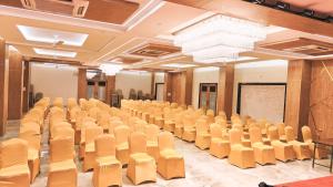 an empty room with chairs and a projection screen at Hotel Laxmibai Palace in Shirdi