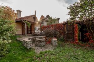 a house with a stone patio in the yard at Villa 1912 in Trenčianske Teplice