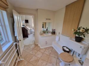 a bathroom with a sink and a toilet in a room at Gorgeous Country Cottage overlooking Windsor Castle in Old Windsor