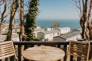 a wooden table and chairs on a balcony with a view at Studio Pod 1 in Portland