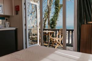 a kitchen with a view of a balcony with a table and chairs at Studio Pod 1 in Portland