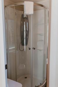 a shower with a glass door in a bathroom at Studio Pod 1 in Portland
