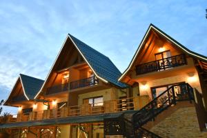 a house with a roof with a balcony at Brvnara Mont 2 in Zlatibor